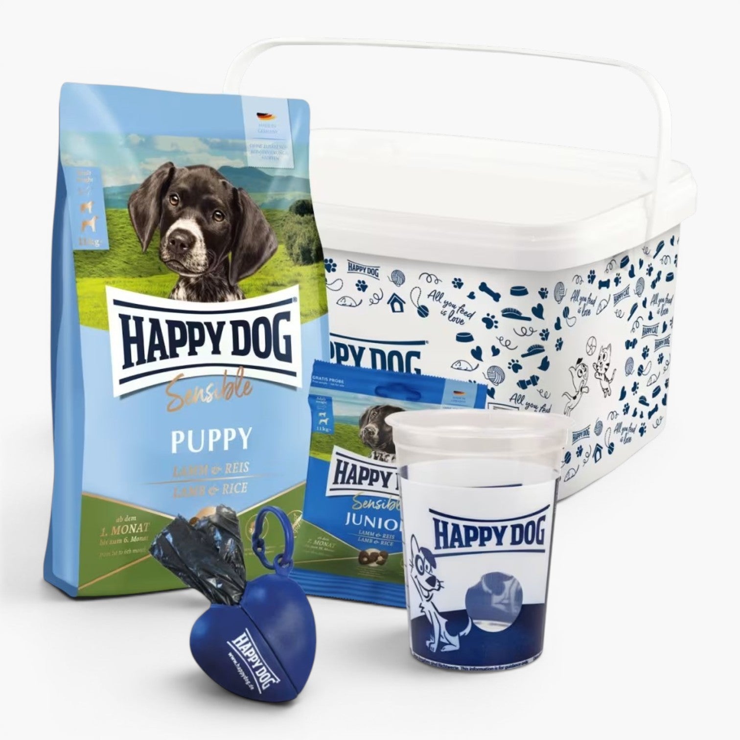 Happy Dog valpepakke med valpefôr, fôrbøtte, målebeger og hundeposeholder