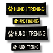 Merker som viser hund i trening